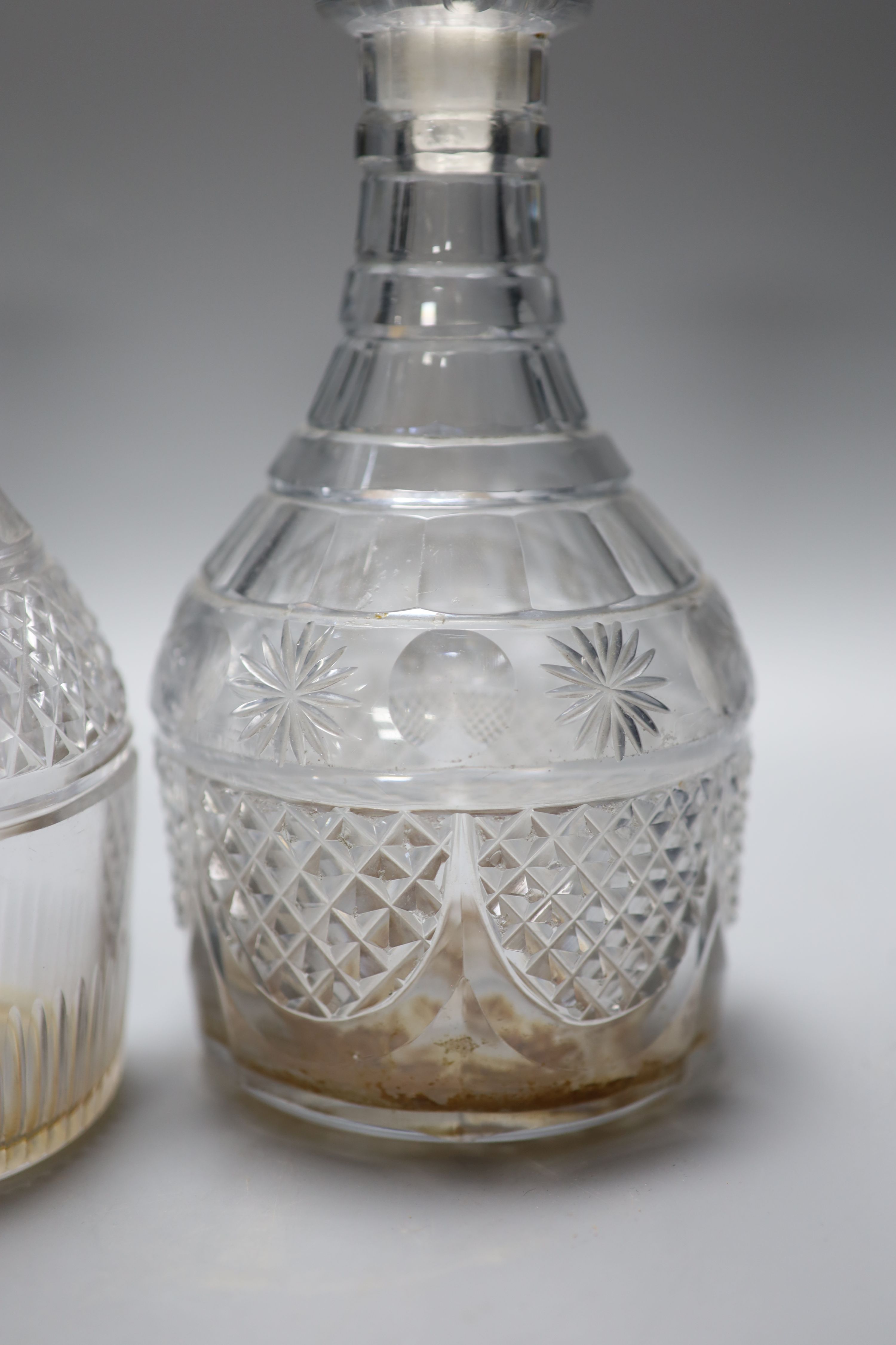 A pair of early 19th century cut glass decanters and one other